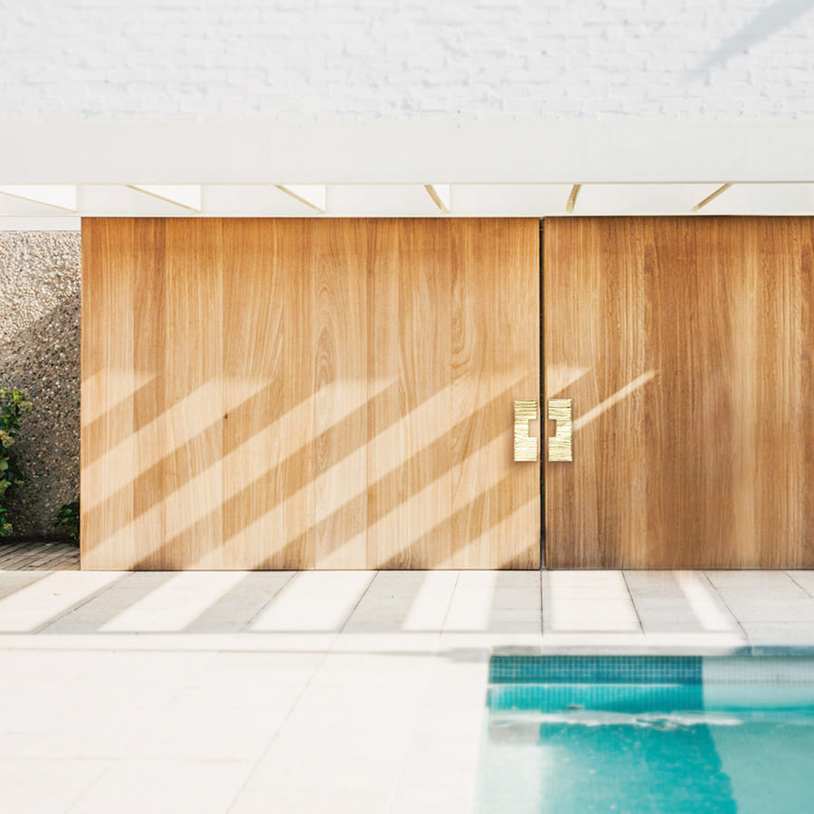 An interior design idea for an elegant entryway with luxurious gold door pulls.